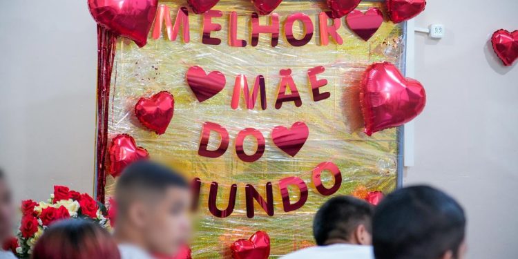 Defensoria Pública celebra Dia das Mães com foco no fortalecimento de vínculos de jovens do sistema socioeducativo Atividade do projeto ‘Ensina-me a Sonhar’ no Centro Dagmar Feitoza contou com palestra do escritor Tenório Telles e confraternização entre filhos e mães A Defensoria Pública do Estado do Amazonas (DPE-AM) realizou, nesta quarta-feira (6), uma atividade especial do projeto “Ensina-me a Sonhar” no Centro Socioeducativo Dagmar Feitoza, localizado no bairro Alvorada, na Zona Centro-Oeste de Manaus. A ação em homenagem ao Dia das Mães, celebrado no próximo domingo, reuniu jovens que cumprem medidas socioeducativas e suas mães, em uma tarde com palestra do escritor Tenório Telles e momento de confraternização. Coordenador do “Ensina-me”, o defensor público Eduardo Ituassú explica que uma das técnicas de abordagem da socioeducação e da ressocialização é a reinserção familiar e o estreitamento dos vínculos familiares. “Muitas vezes, os adolescentes quando passam por esses problemas estão com os vínculos familiares fragilizados e até rompidos. Então, a equipe técnica faz esse trabalho de reestreitar o vínculo, e a Defensoria vem buscando isso também”, disse. “Por isso, trouxemos mães biológicas e afetivas para esse momento, essa tarde de poesia, de reflexão e exemplos, mostrando que todos nós temos problemas, mas todos nós também temos capacidade de superá-los”, pontuou. A iniciativa foi recebida com emoção pelas mães presentes. Mariana de Oliveira Gomes disse que momentos como esse são essenciais para que os jovens compreendam o valor da união familiar em suas vidas. “Hoje percebi que todos nós temos lutas parecidas. E nós não podemos desistir dos nossos filhos, porque eles são presentes de Deus nas nossas vidas”, afirmou. O sentimento de esperança também foi compartilhado por Grasiane Rodrigues Andrade, que vê no projeto uma oportunidade de recomeço após períodos de extrema dificuldade. “É um incentivo e uma ajuda muito grande. É um recomeço para nós, como mães, e para nossos filhos voltarem a sonhar”, disse. Grasiane relatou sua luta pessoal, mencionando que o filho chegou a viver em situação de rua por meses e que ela enfrentou a depressão, mas que hoje vive um momento de renovação. “Para mim é uma esperança nova. Acredito que hoje meu filho está por cima de tudo o que ele passou, assim como todos os jovens que estão aqui”, acrescentou. Palestrante convidado, o escritor Tenório Telles contou um pouco de sua trajetória e a importância do apoio e aconselhamento da mãe para o seu desenvolvimento pessoal. Sobre o diálogo com os jovens e suas mães, ele descreveu a experiência como um momento de profunda humanidade e solidariedade. Conforme o escritor, ouvir os relatos de sacrifício das mães reforça a necessidade de ações coletivas para o resgate dos jovens. “São momentos que nos fazem ver como podemos contribuir para o processo de resgate da vida das pessoas, em especial dos jovens. O ‘Ensina-me a Sonhar’ é um projeto de profunda humanidade e um exemplo do que pode ser feito para melhorar a sociedade e proporcionar oportunidades para famílias que, muitas vezes, vivem no desespero”, observou Telles. “Saio daqui contente, muito feliz de ver que esse trabalho está dando resultados e que muitas mães estão conseguindo resgatar seus filhos da violência”, concluiu. A atividade contou com a participação das defensoras Monique Cruz e Dâmea Mourão, também coordenadoras do “Ensina-me a Sonhar”, e com o apoio técnico dos servidores da Secretaria de Justiça, Cidadania e Direitos Humanos (Sejusc). Sobre o projeto Lançado em 2017, o projeto “Ensina-me a Sonhar” promove para jovens em cumprimento de medidas socioeducativas oficinas, palestras e ações formativas voltadas à educação, cidadania e inserção no mercado de trabalho, evitando reincidências. Profissionais de diversas áreas conversam com os jovens, visando ampliar perspectivas para os adolescentes. “Buscamos mostrar para os adolescentes que todos nós passamos problemas, mas todos nós temos a capacidade de nos reinventar. Então, o Ensina-me a Sonhar mostra as possibilidades, procurando dar um novo caminho e mostrar para a família que tudo é possível”, explicou o defensor Eduardo Ituassú. Texto: Luciano Falbo Fotos: Luiz Felipe Santos/DPE-AM
